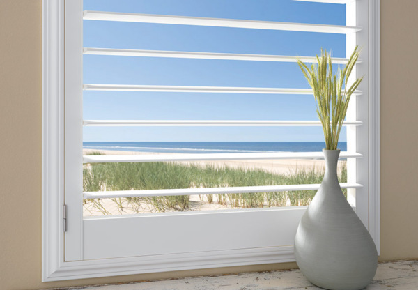 Plantation shutters with 4.5inch louver by a shade above window fashions