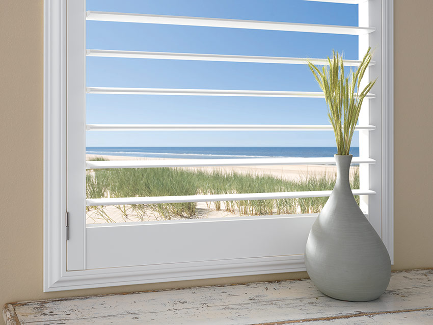 Plantation shutters with 4.5inch louver by a shade above window fashions