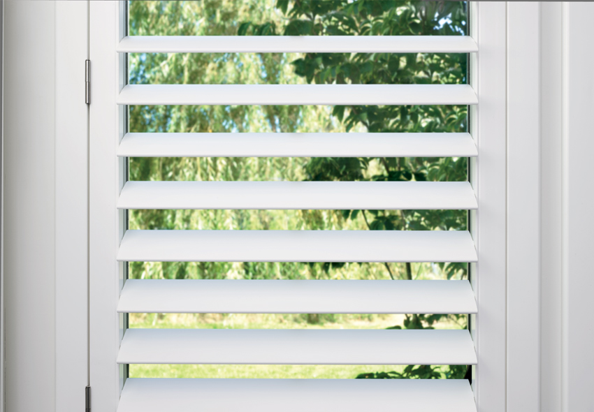 plantation shutters with hidden tilt bar by a shade above window fashions