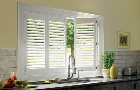 plantation shutters in kithen above sink by a shade above window fashions